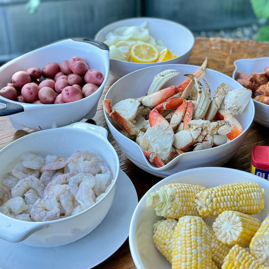 Wild Dungeness crab and wild shrimp seafood boil bundle with corn, potatoes, and lemon.
