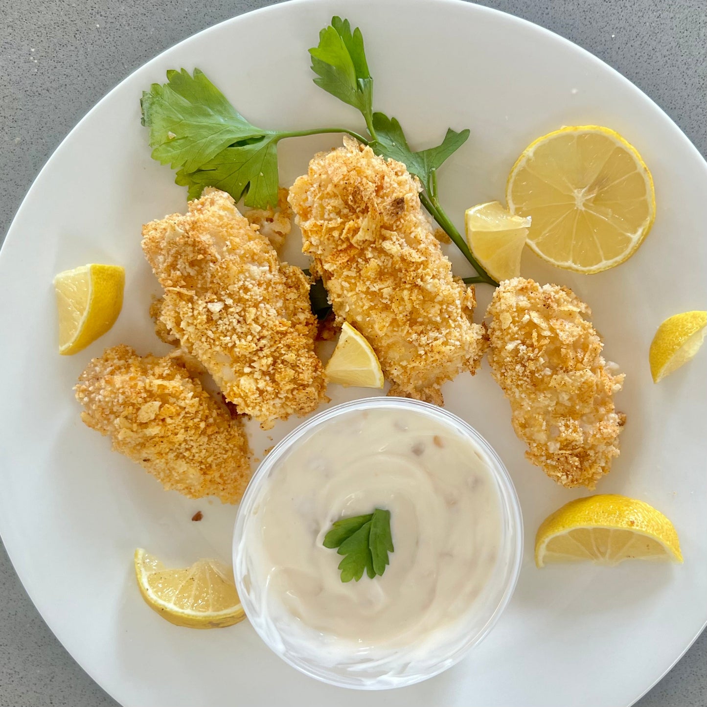 Potato crusted wild Alaska cod served with lemon aioli and fresh lemon wedges.