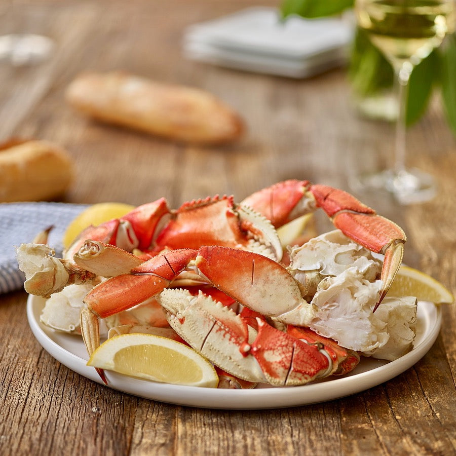 Plated wild Alaskan Dungeness crab legs with lemon
