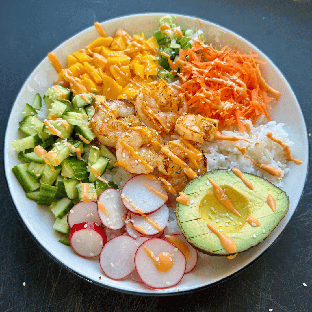 Shrimp bowl made with wild Gulf shrimp, avocado, cucumber, radish, shredded carrot, and rice