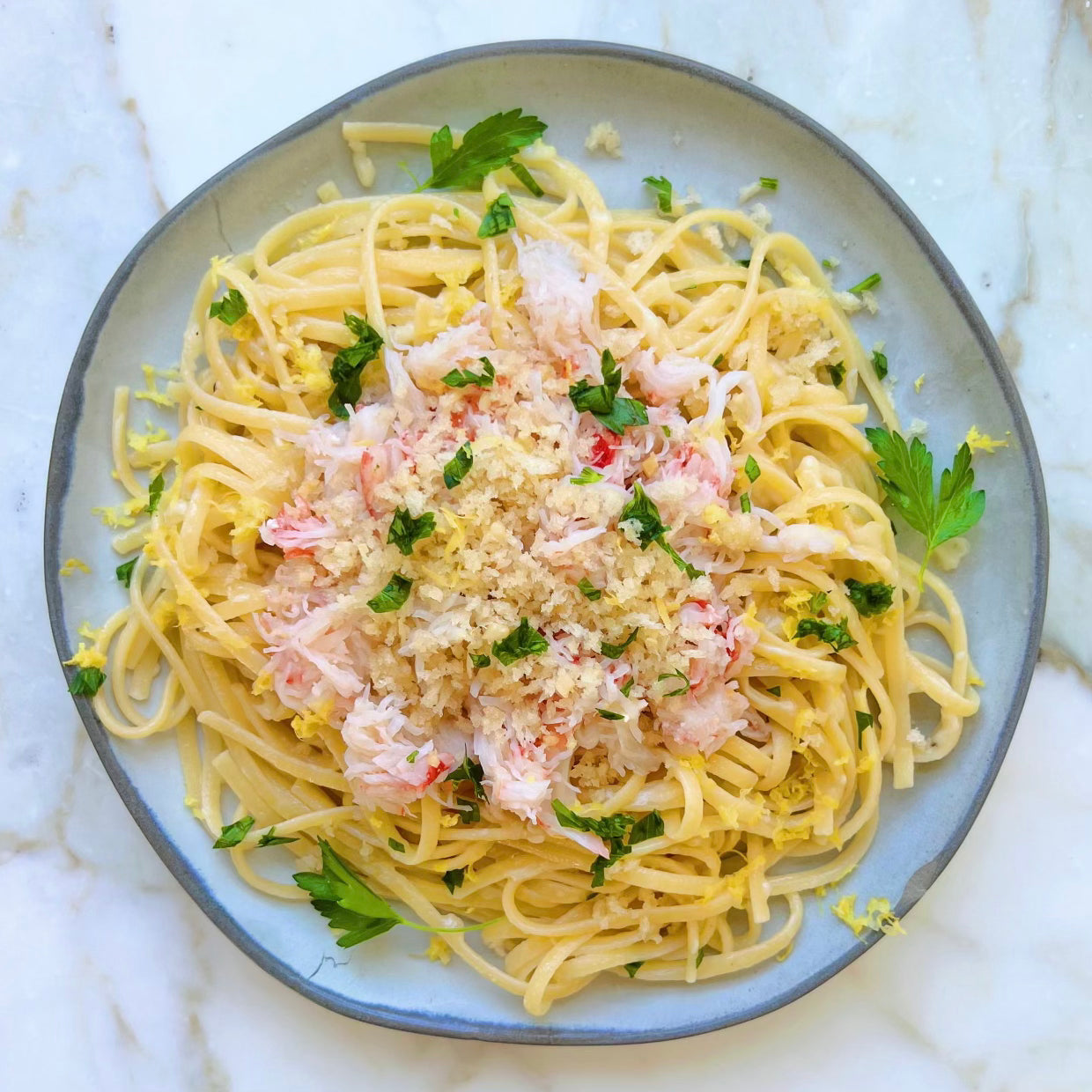Creamy pasta topped with wild snow crab meat and parsley