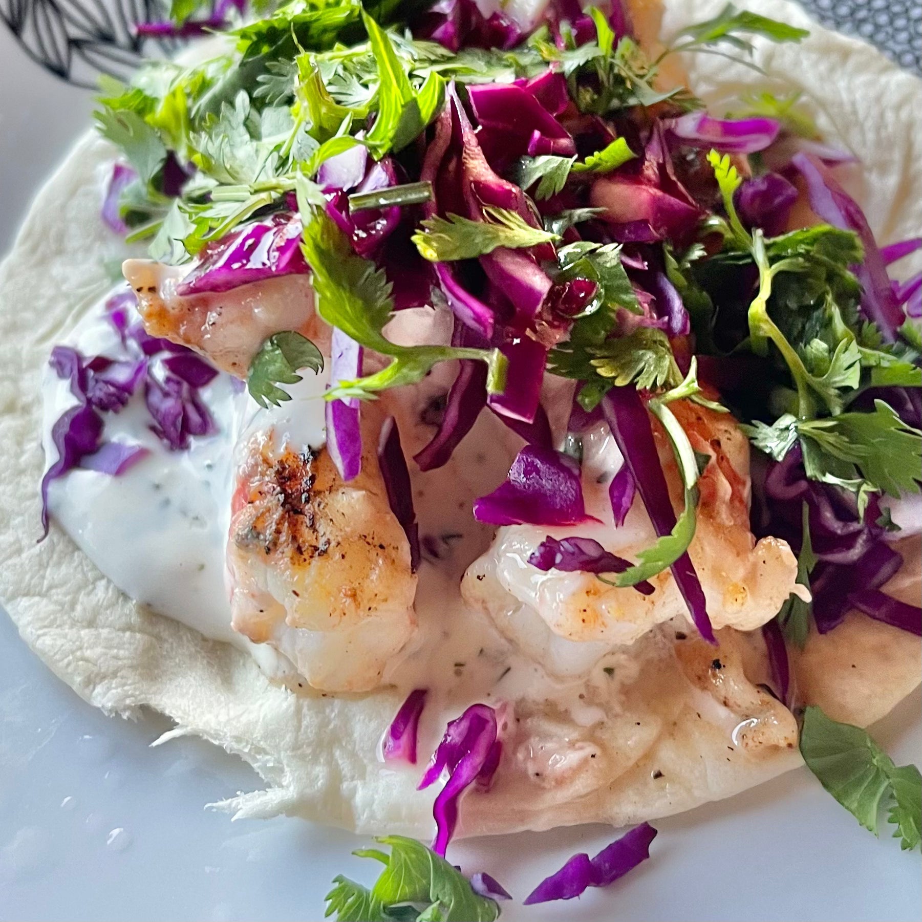 Spot prawn taco topped with wild Alaskan spot prawns and fresh cabbage slaw