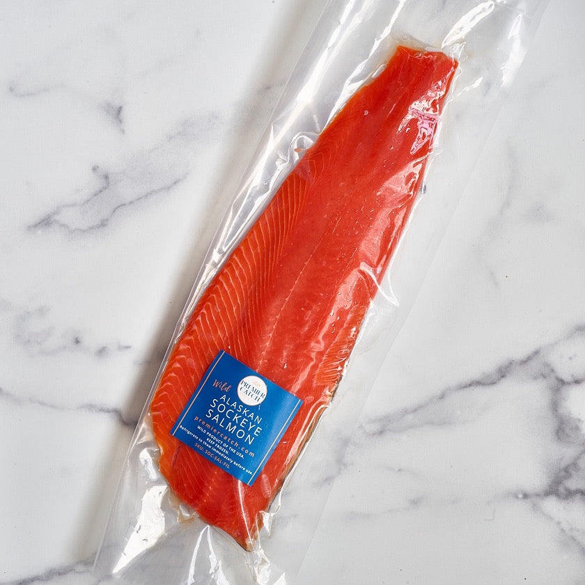 Wild Alaskan sockeye salmon fillet vacuum sealed in Premier Catch packaging.