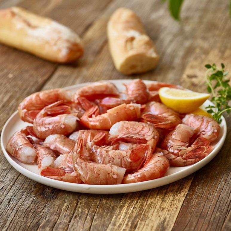wild Alaskan spot prawns served on a platter with lemon and bread