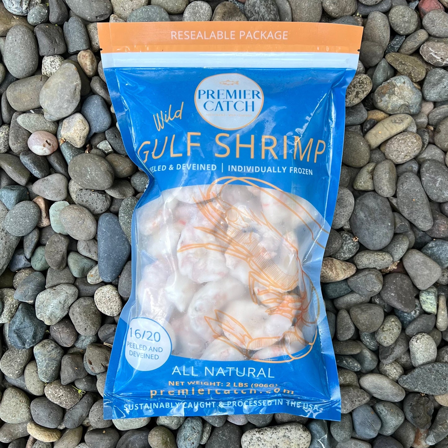 Premier Catch wild Gulf shrimp retail package displayed on beach stones